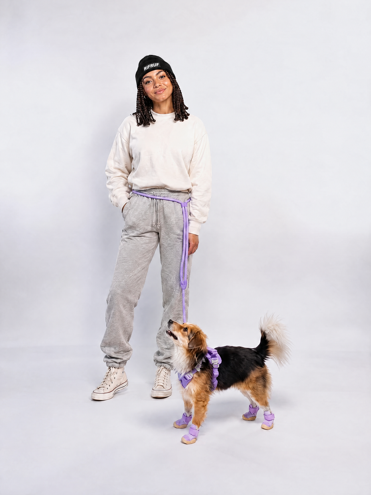 Model wearing the black RIFRUF Beanie with her dog in lavender RIFRUF harness, leash and shoes